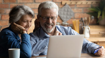 Mature couple shopping for home insurance online